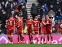 Aberdeen's Bojan Miovski celebrates scoring their first goal with teammates on February 6, 2024