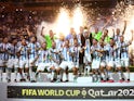 Argentina's Lionel Messi celebrates with the trophy and teammates after winning the World Cup on December 18, 2022