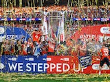 General view of a giant replica trophy as Luton Town's Sonny Bradley lifts the trophy with the team after winning the Championship Playoff Final on May 27, 2023